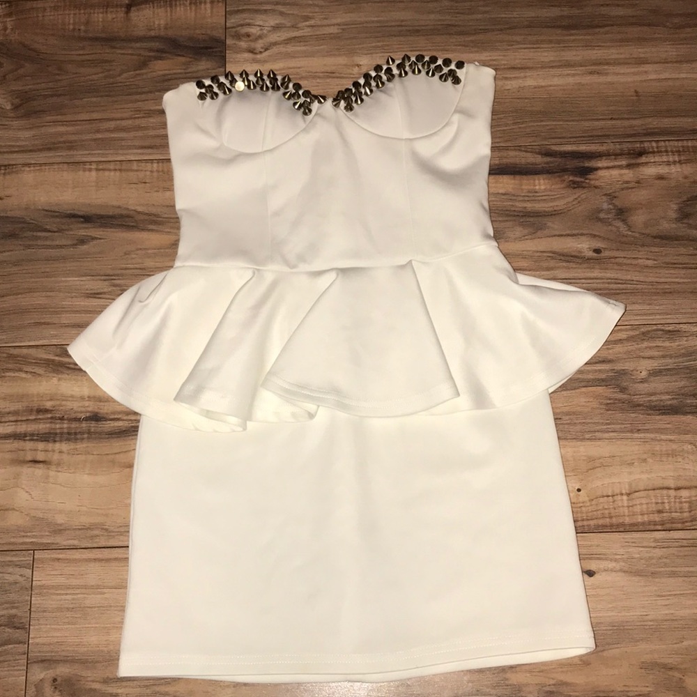 A white mini dress with golden spikes